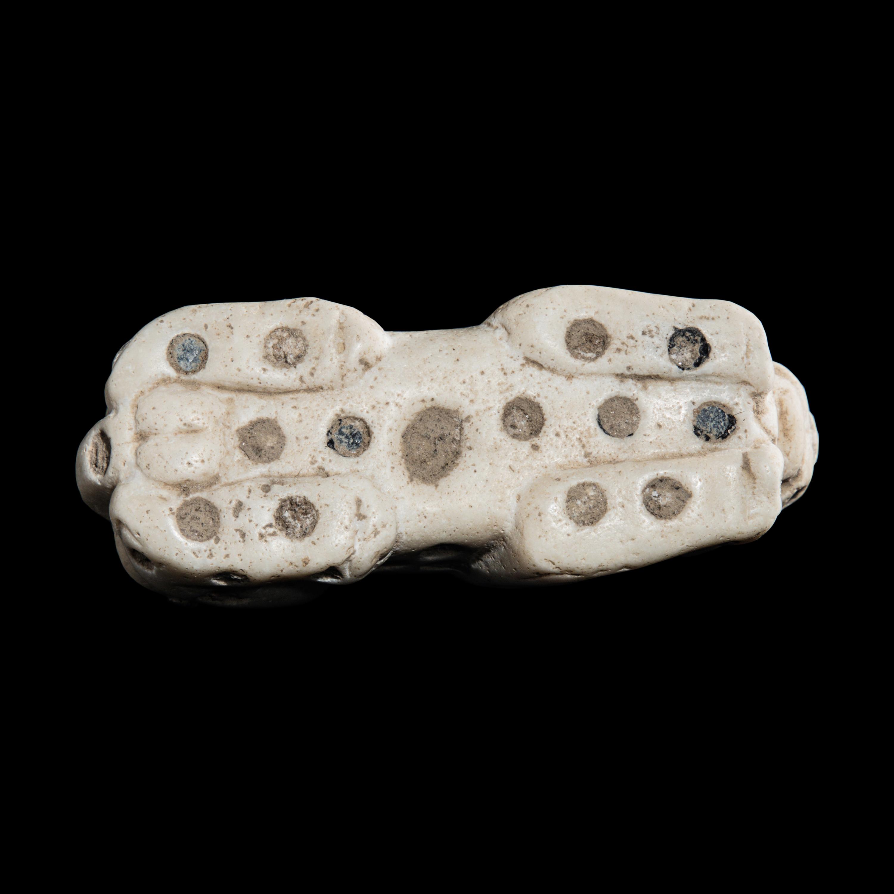 A Mesopotamian Marble and Lapis Lazuli Inlay Recumbent Feline