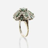 An irradiated green diamond, diamond, and white gold cocktail ring