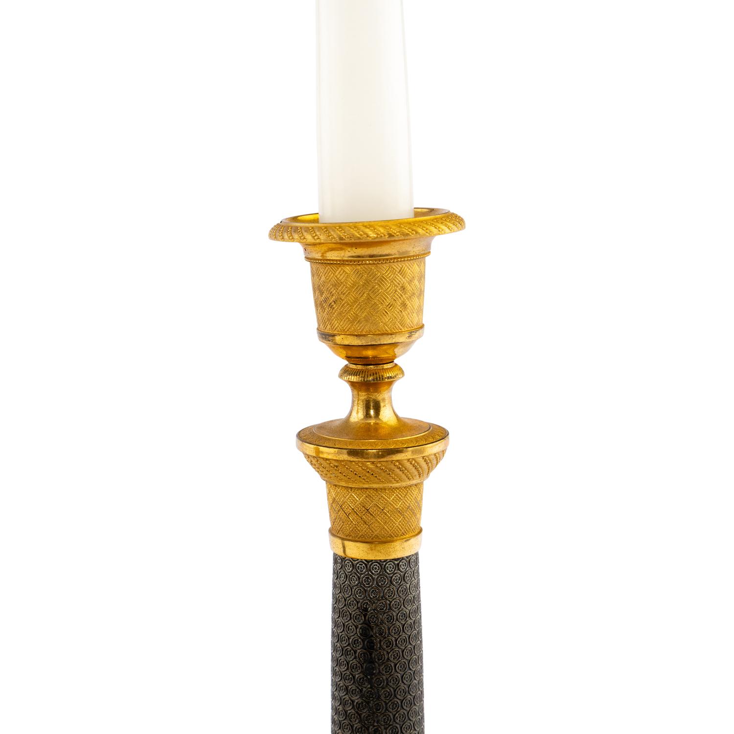 A Pair of Continental Gilt and Patinated Bronze Candlesticks