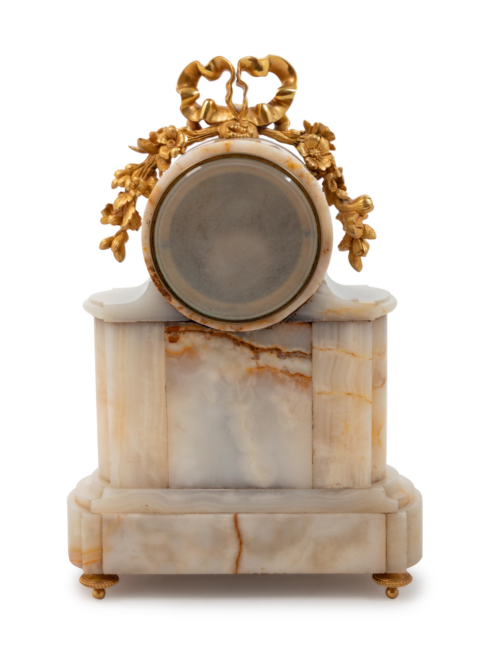 A Louis XVI Style Gilt Bronze Mounted Onyx Mantel Clock