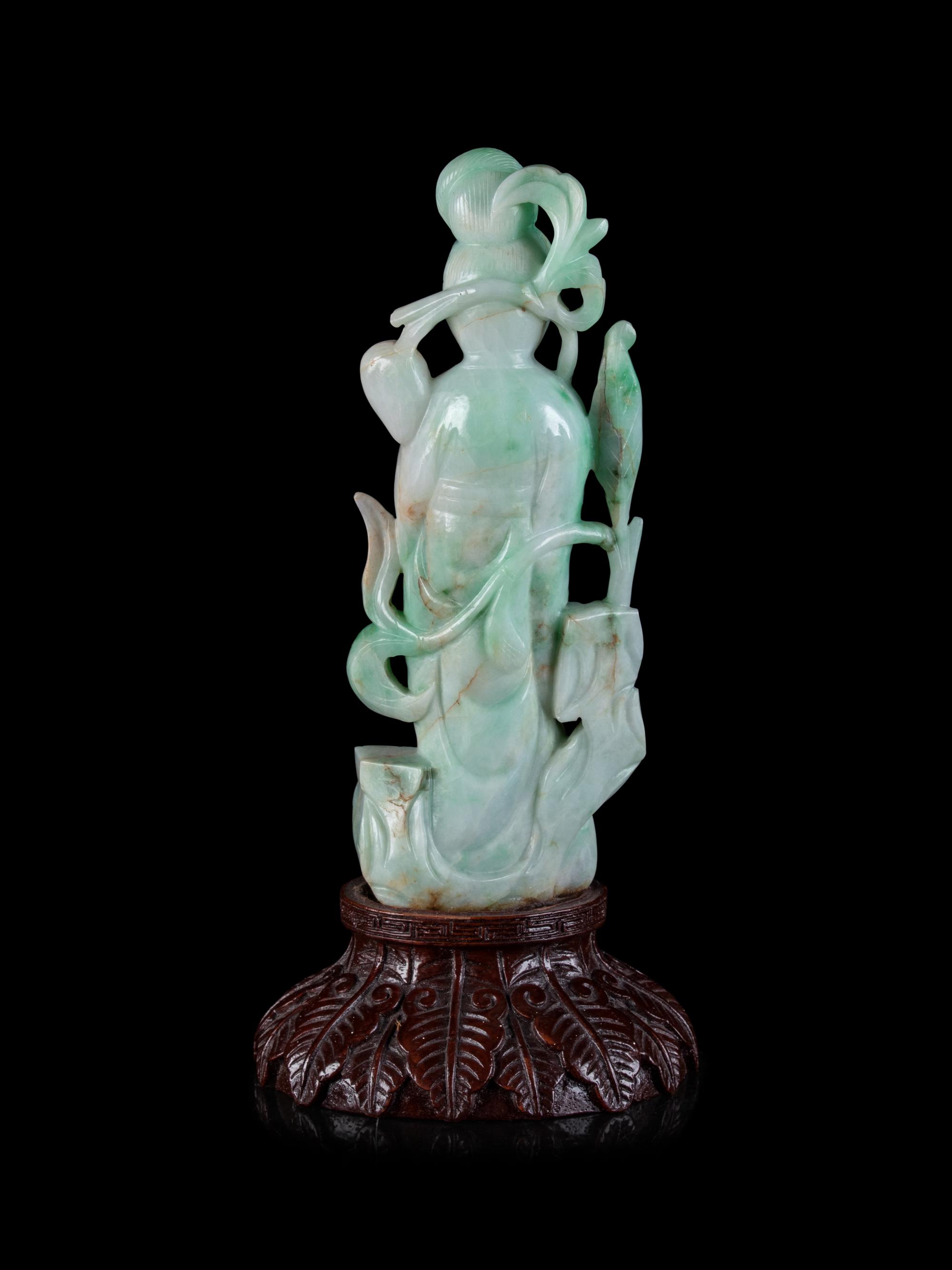 A Chinese Apple Green and Pale Celadon Jadeite Figure of Guanyin