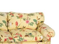 A Yellow Floral Chintz Upholstered Sofa and a Pair of Matching Drapes