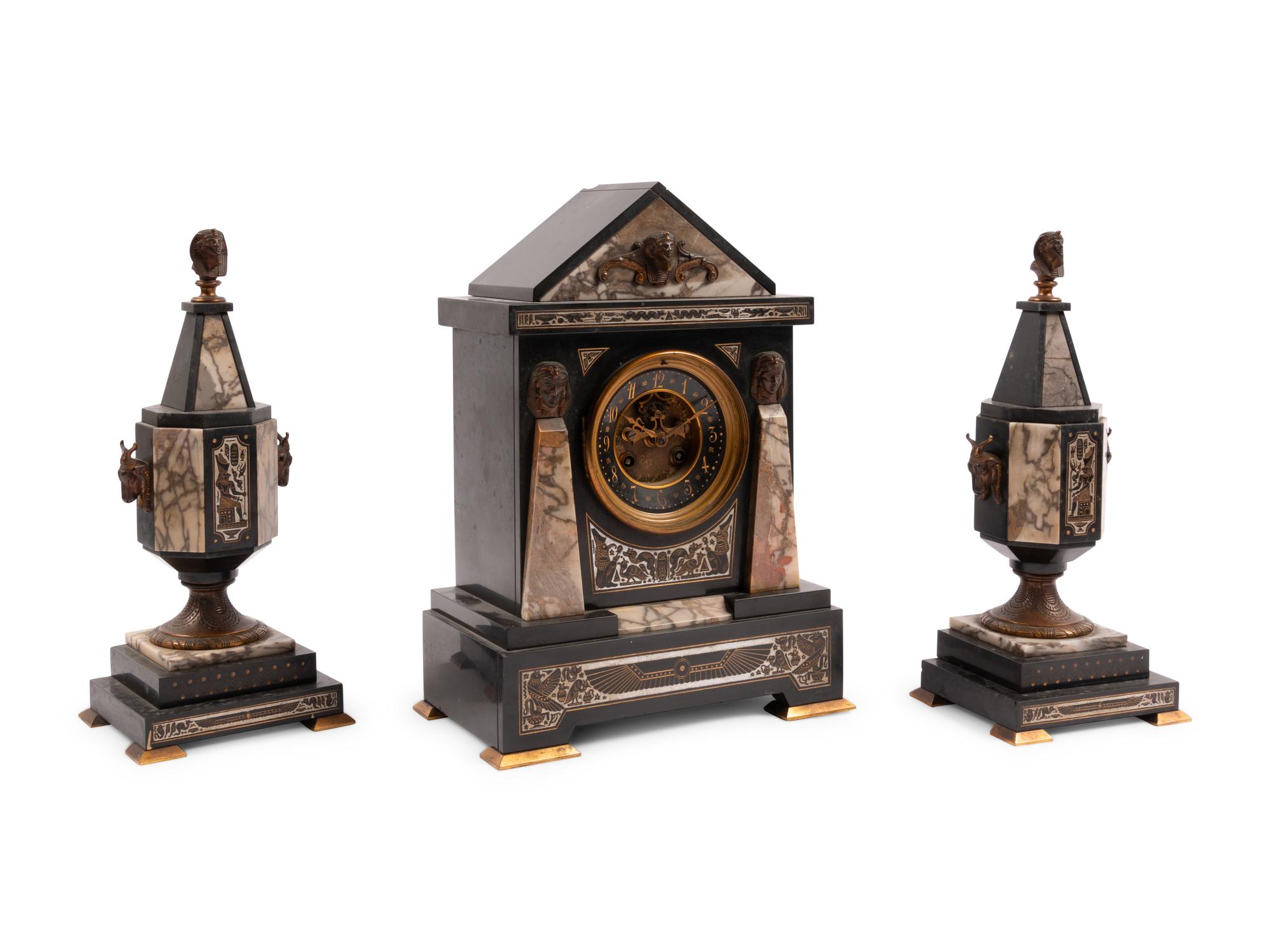 An Egyptian Revival Marble and Patinated Bronze Mantel Clock Garniture
