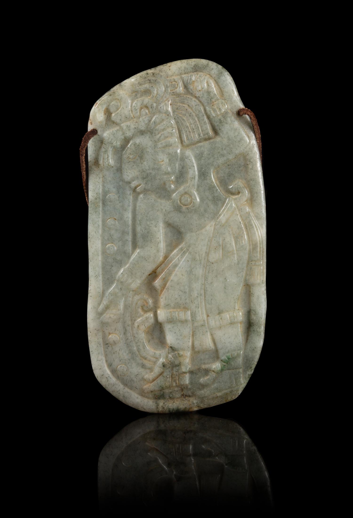 A Celadon Jade Plaque Carved with a Mexican Figure. Height 6 1/4 inches.
