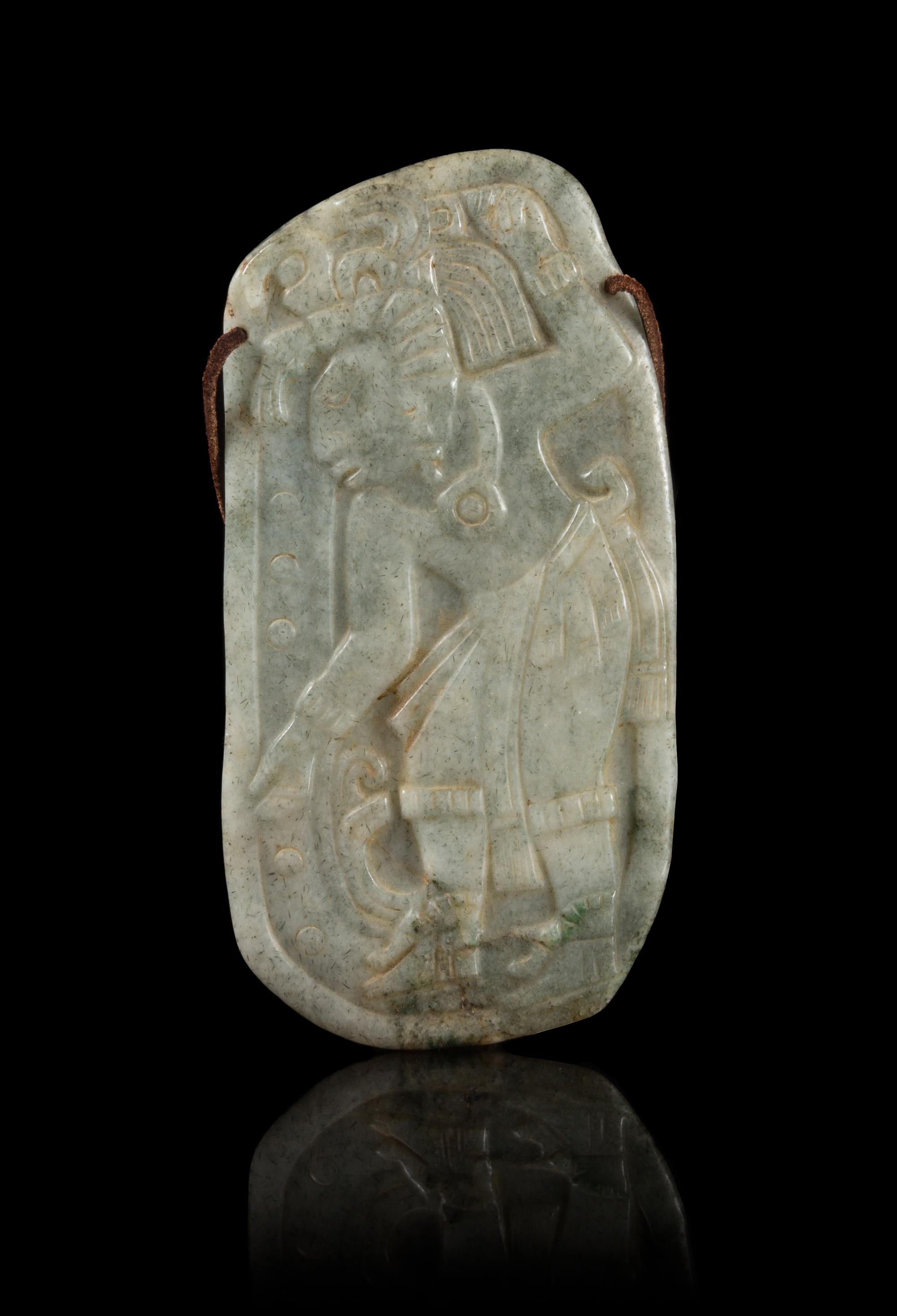 A Celadon Jade Plaque Carved with a Mexican Figure. Height 6 1/4 inches.