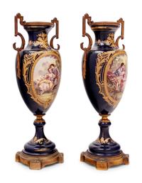 A Pair of Sèvres Style Gilt Bronze Mounted Porcelain Urns