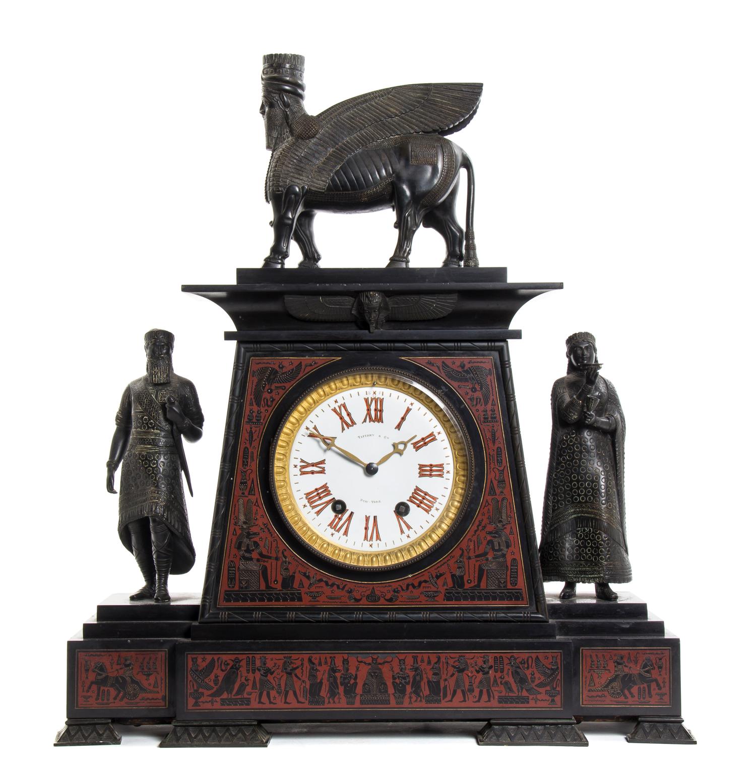 A French Egyptian Revival Bronze and Marble Mantel Clock, retailed by Tiffany & Co., Height overall 24 inches.