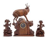 A Black Forest Carved Clock Garniture