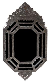 A Baroque Style Repousse Metal Mounted Mirror Height 44 x width 24 1/4 inches.