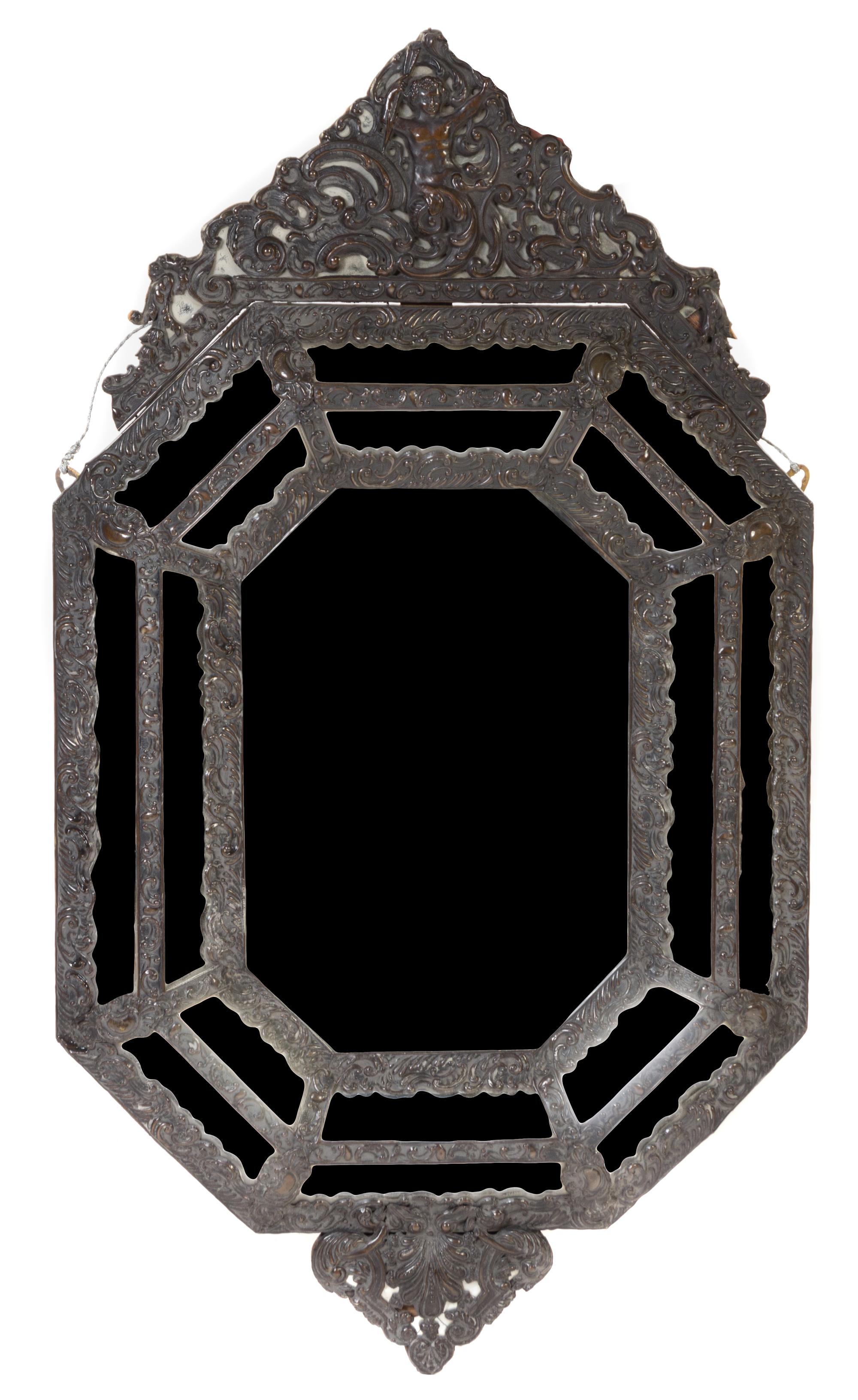 A Baroque Style Repousse Metal Mounted Mirror Height 44 x width 24 1/4 inches.