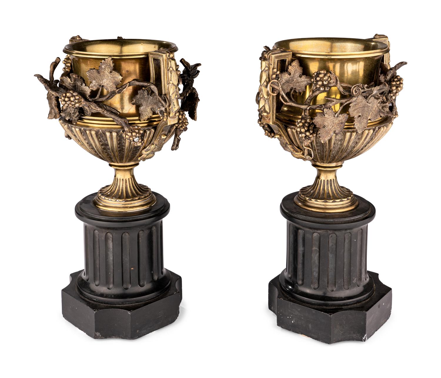 A Pair of Continental Gilt Bronze Urns on Slate Plinths