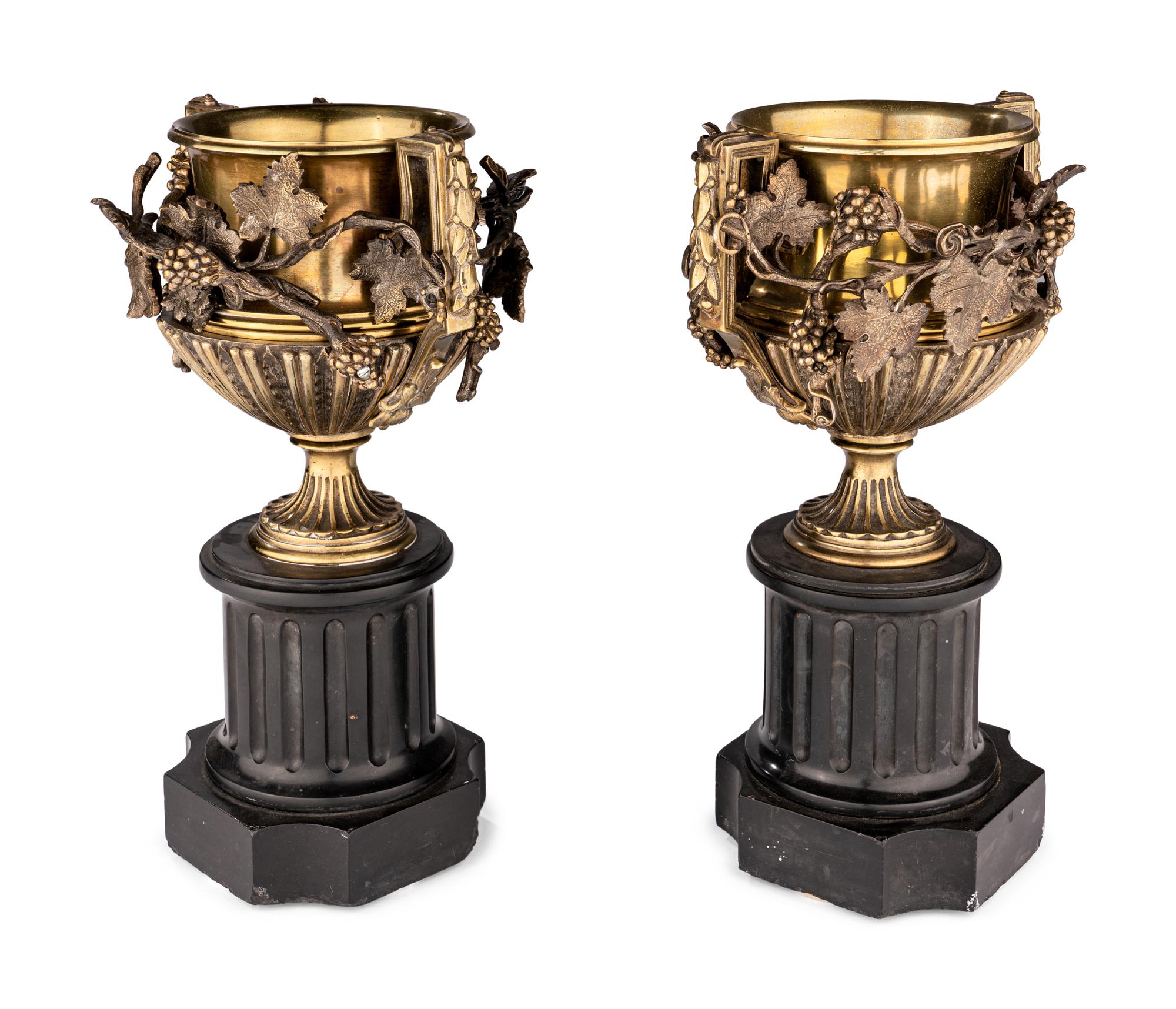 A Pair of Continental Gilt Bronze Urns on Slate Plinths
