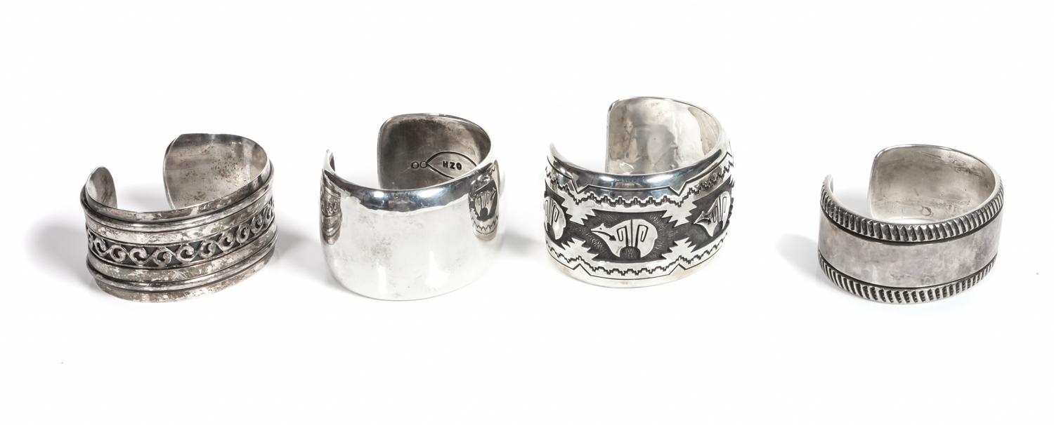 Four Southwestern Silver Bracelets Length of one 5 5/8 x opening 1 1/4 x width 1 1/2 inches