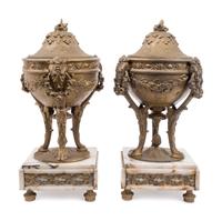 A Pair of Gilt Metal Urns on Onyx Bases — 20TH CENTURY
