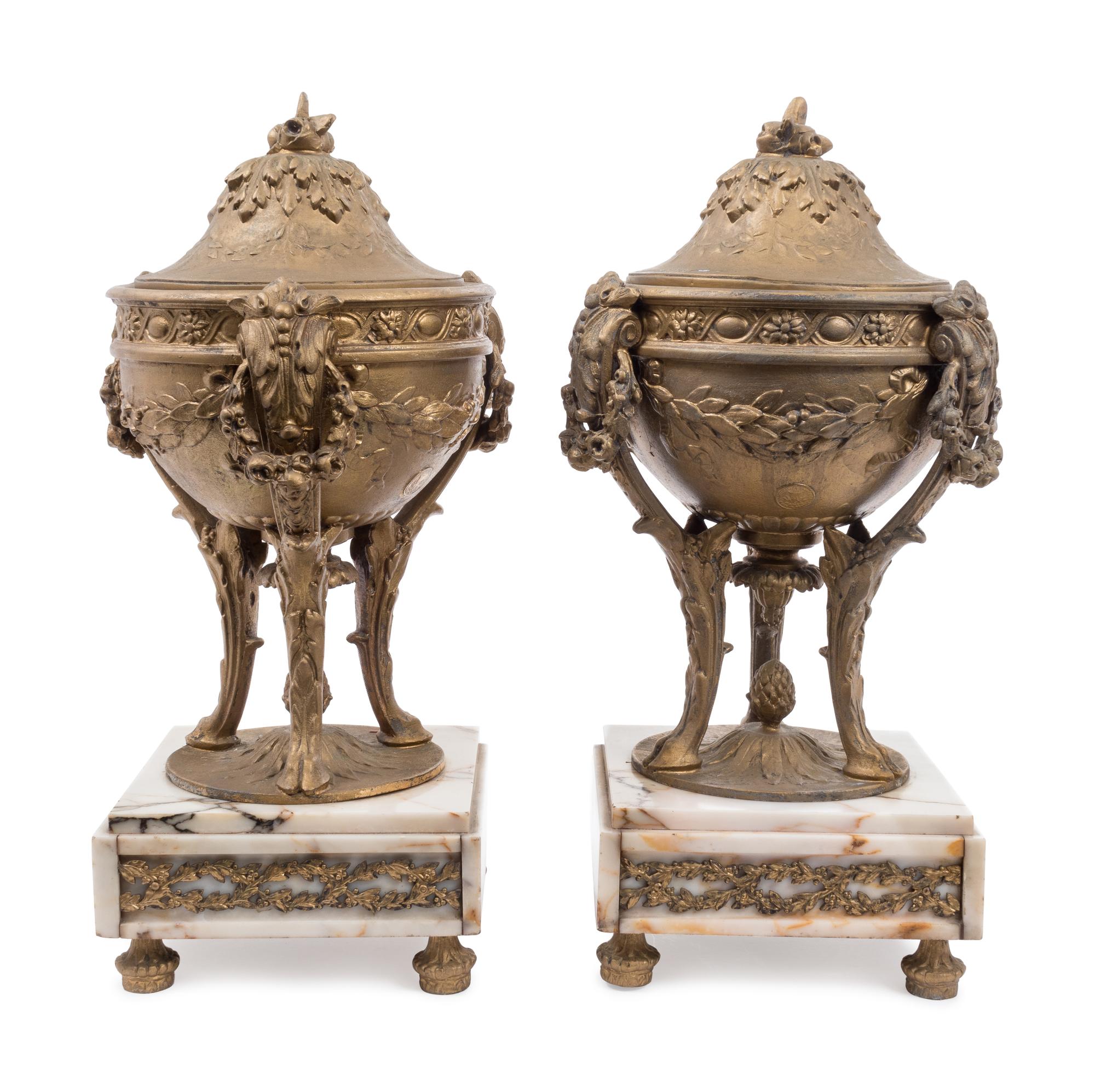 A Pair of Gilt Metal Urns on Onyx Bases — 20TH CENTURY