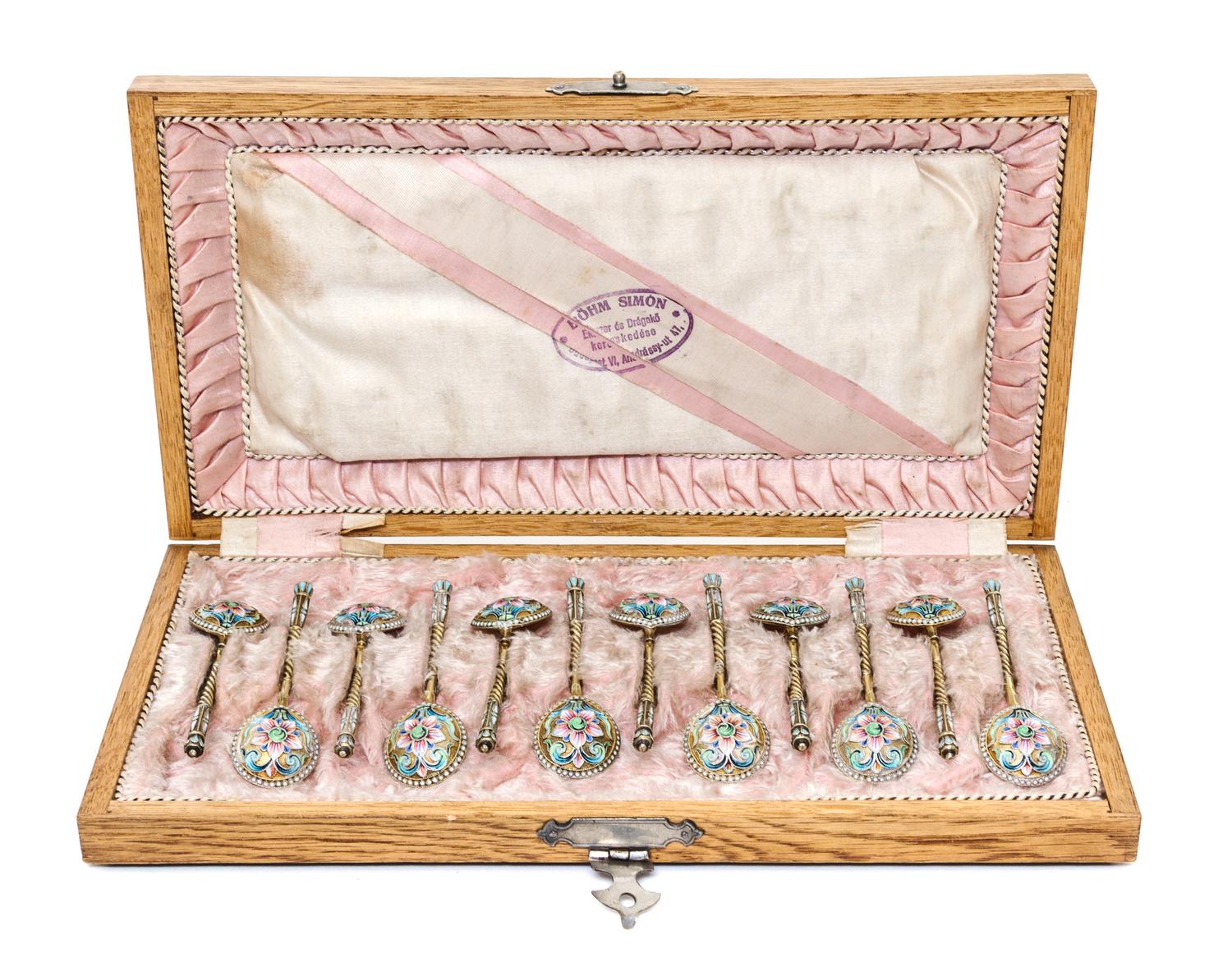 A Set of Twelve Russian Enameled Silver-Gilt Spoons, Mark of Vasiliy Agafonov, Moscow, late 19th/early 20th century, each having a twis