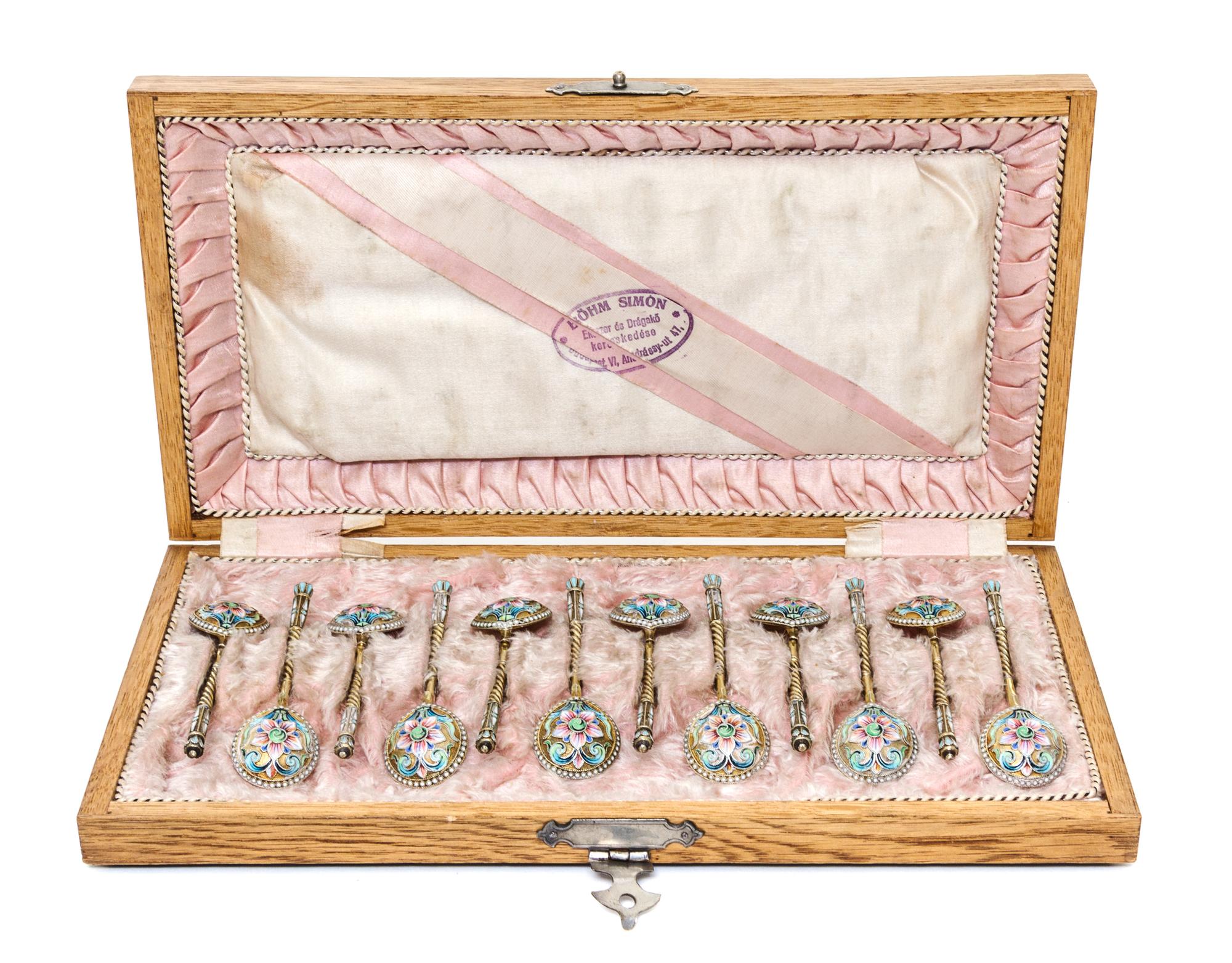A Set of Twelve Russian Enameled Silver-Gilt Spoons, Mark of Vasiliy Agafonov, Moscow, late 19th/early 20th century, each having a twis