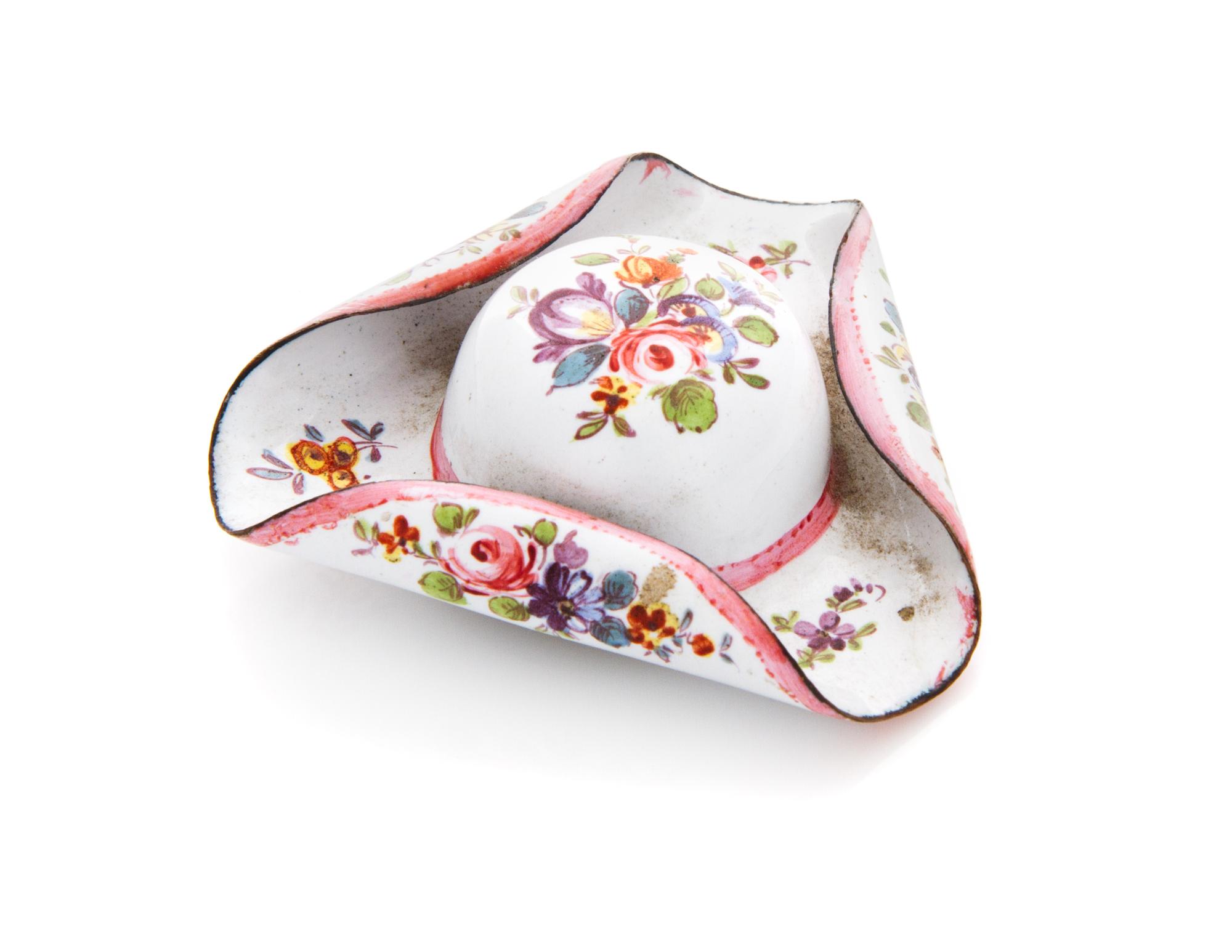 A Continental Enameled Pill Box, 18th/19th Century, in the form of a tricorne hat, decorated with polychrome floral sprays, the door de