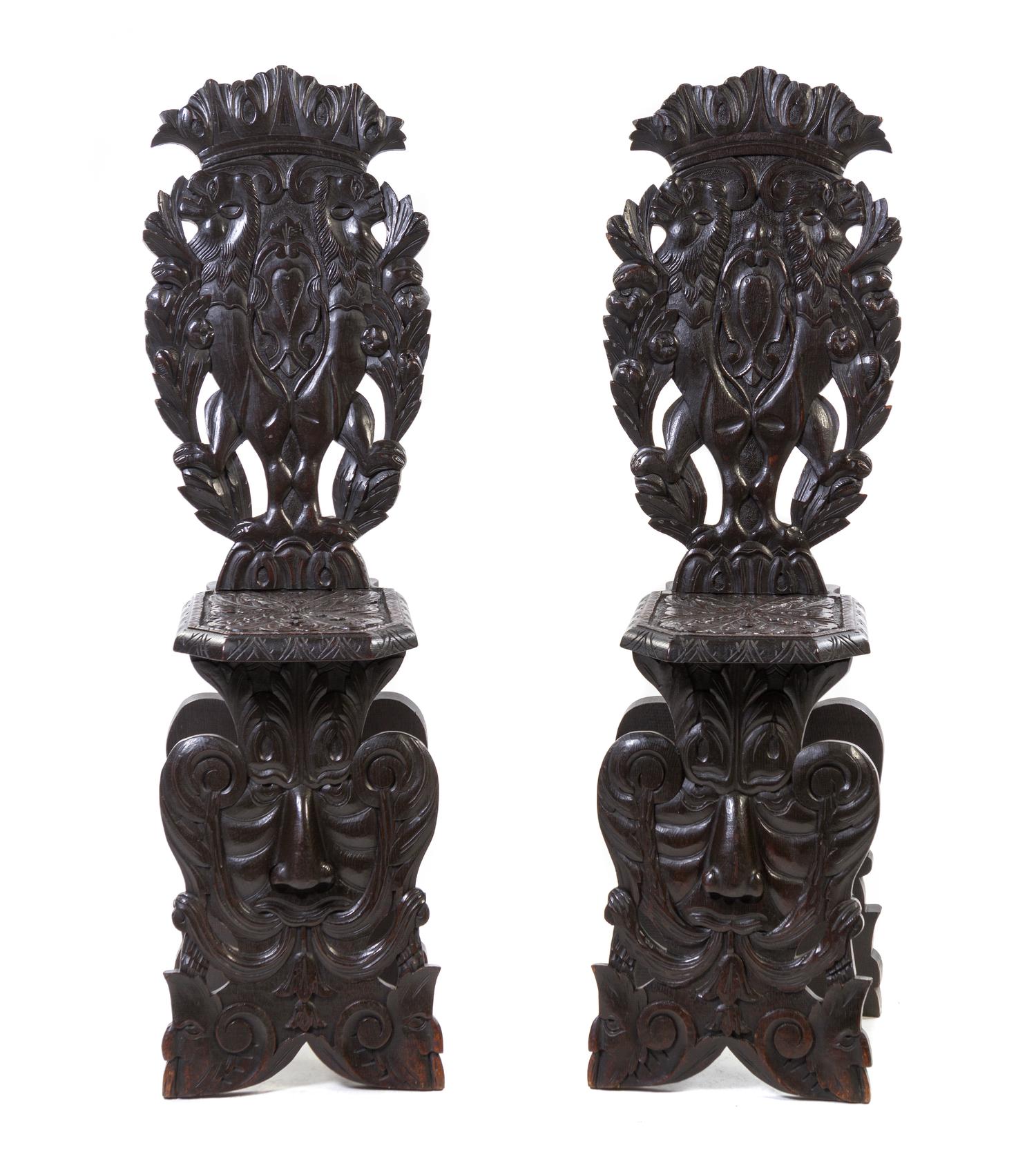A Pair of Renaissance Revival Carved Oak Hall Chairs, Height 49 1/2 inches.