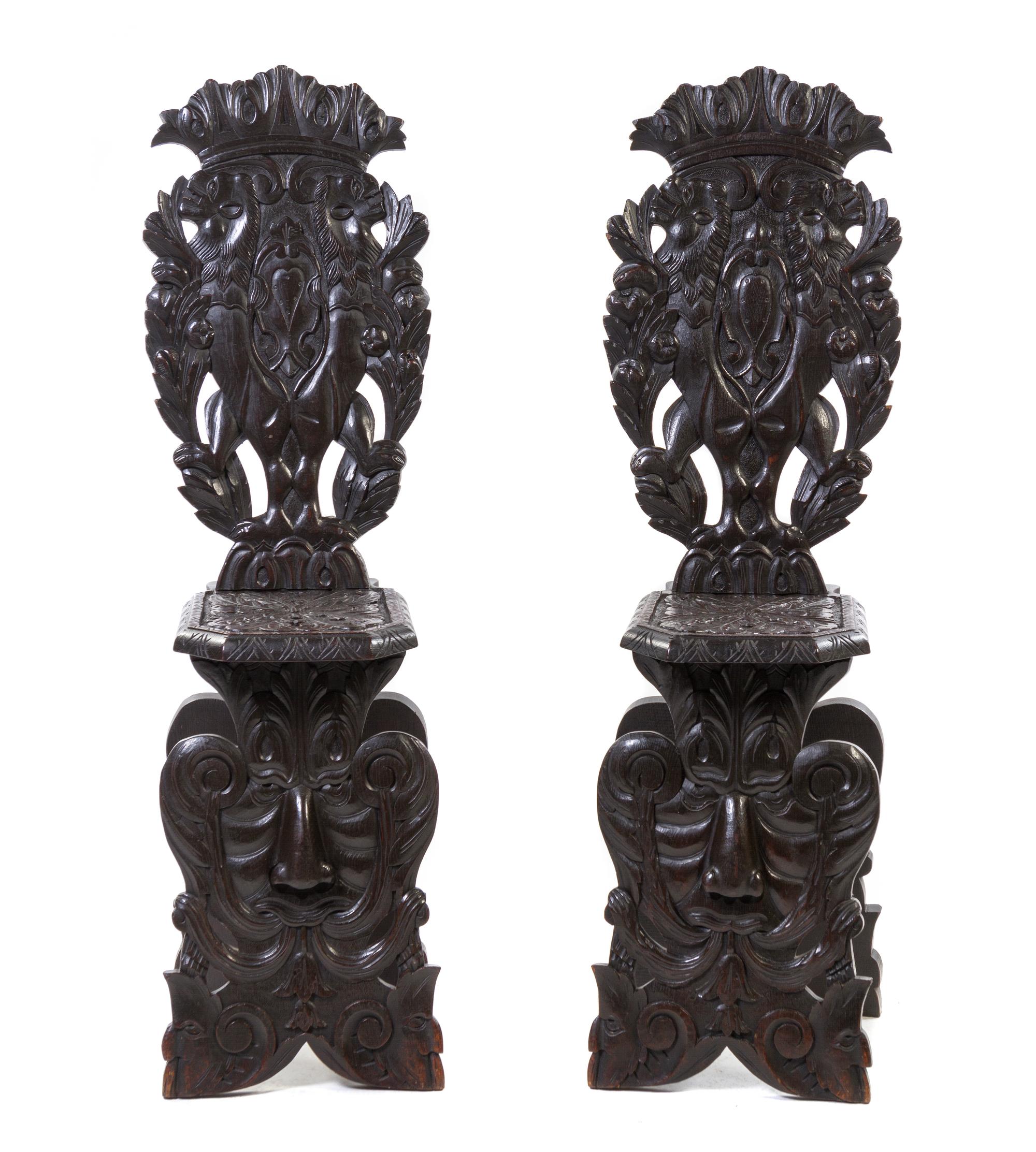 A Pair of Renaissance Revival Carved Oak Hall Chairs, Height 49 1/2 inches.