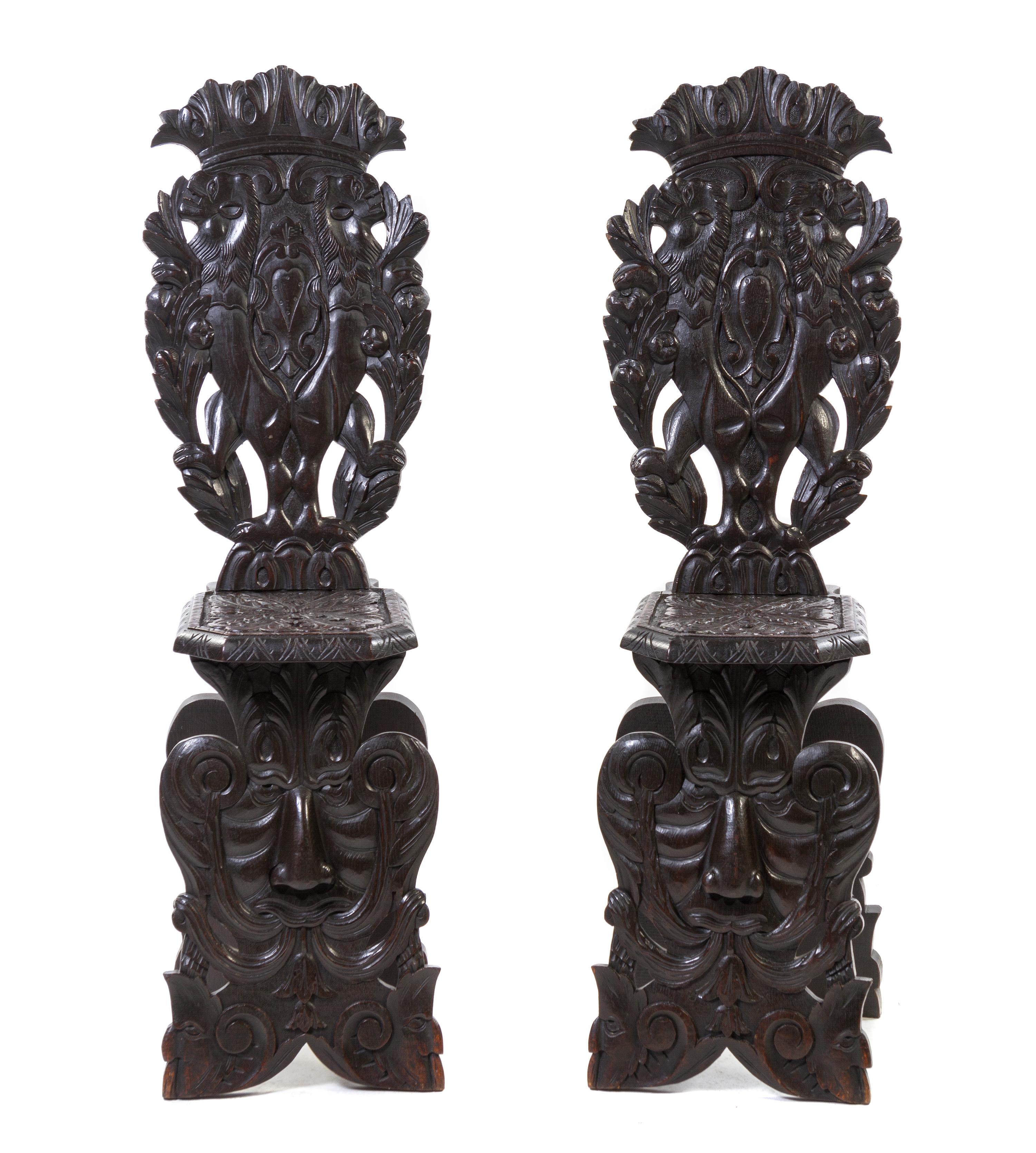 A Pair of Renaissance Revival Carved Oak Hall Chairs, Height 49 1/2 inches.