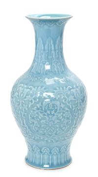 A Chinese Blue Glazed Carved Porcelain Bottle Vase Height 13 3/4 inches. — 20TH CENTURY