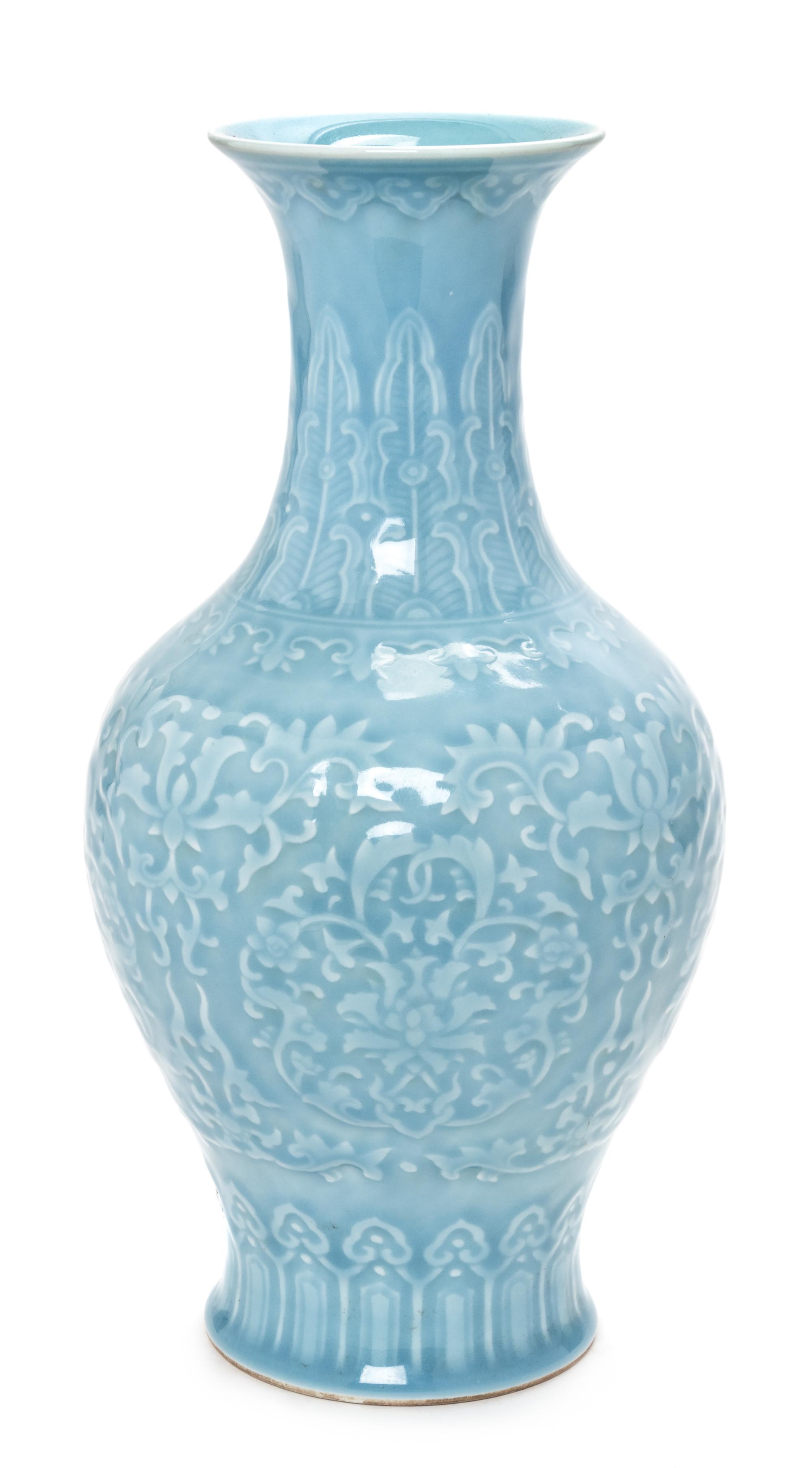 A Chinese Blue Glazed Carved Porcelain Bottle Vase Height 13 3/4 inches. — 20TH CENTURY