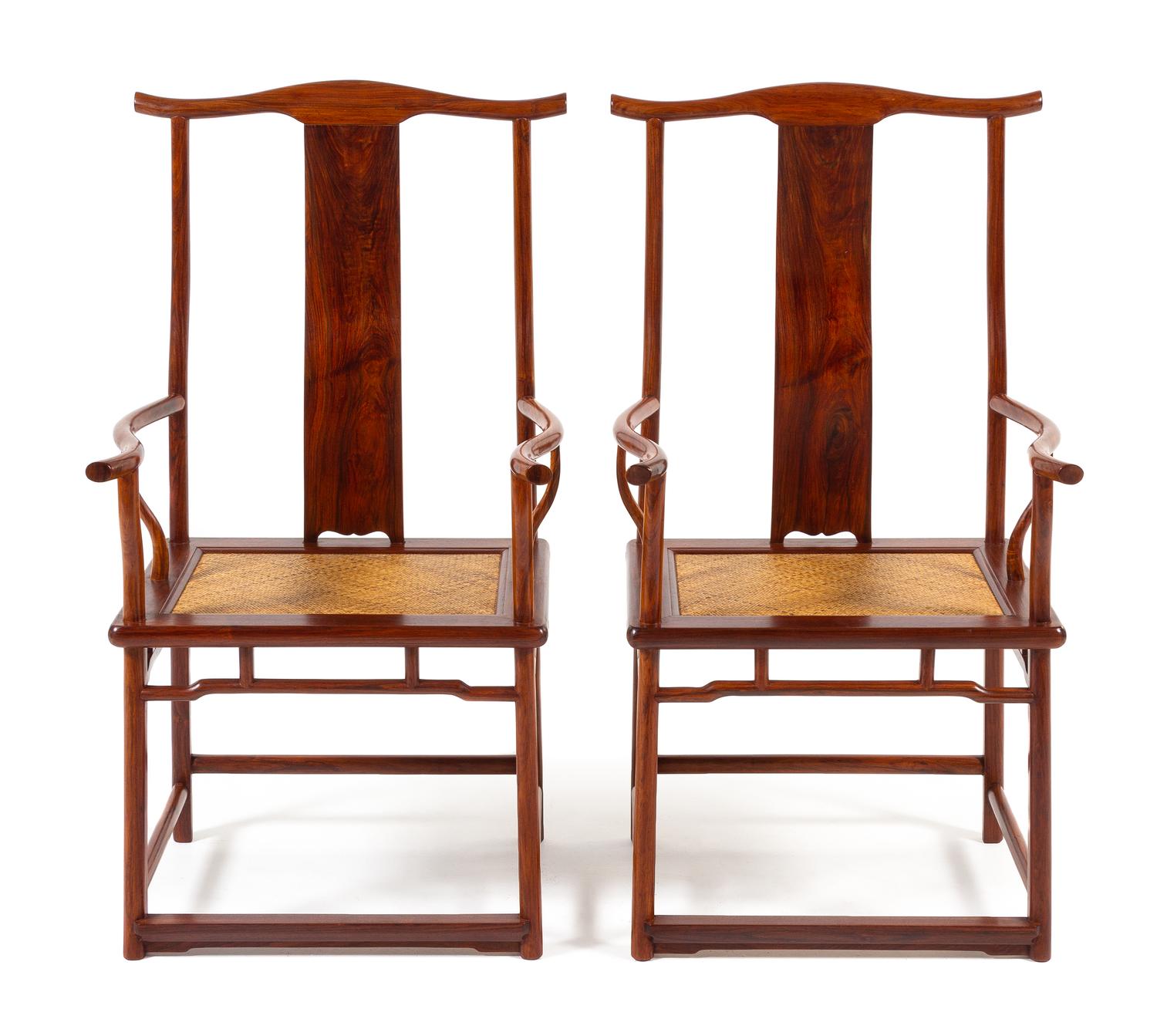 A Pair of Chinese Huanghuali Official's Hat Armchairs, Sichutouguanmaoyi Each height 44 3/4 x width 24 1/2 x depth 20 inches. — QING DYNASTY (1644-1911)