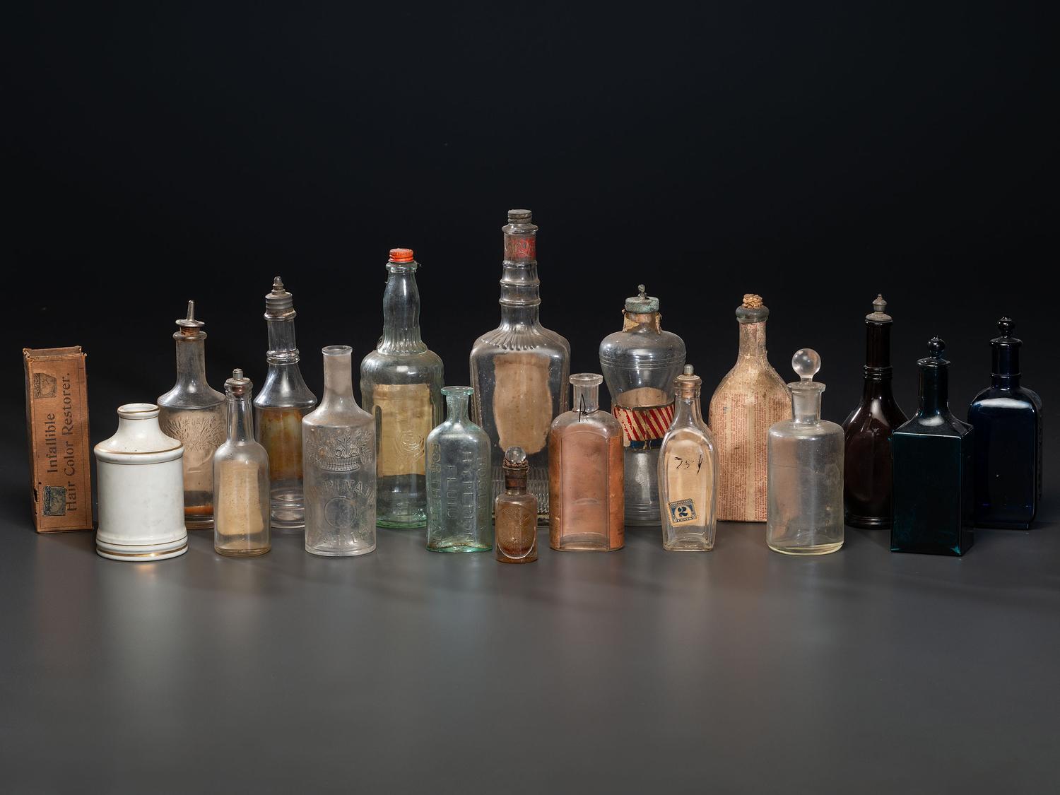 Eighteen Pressed Glass and Porcelain Hair Tonic Bottles