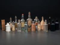 Eighteen Pressed Glass and Porcelain Hair Tonic Bottles
