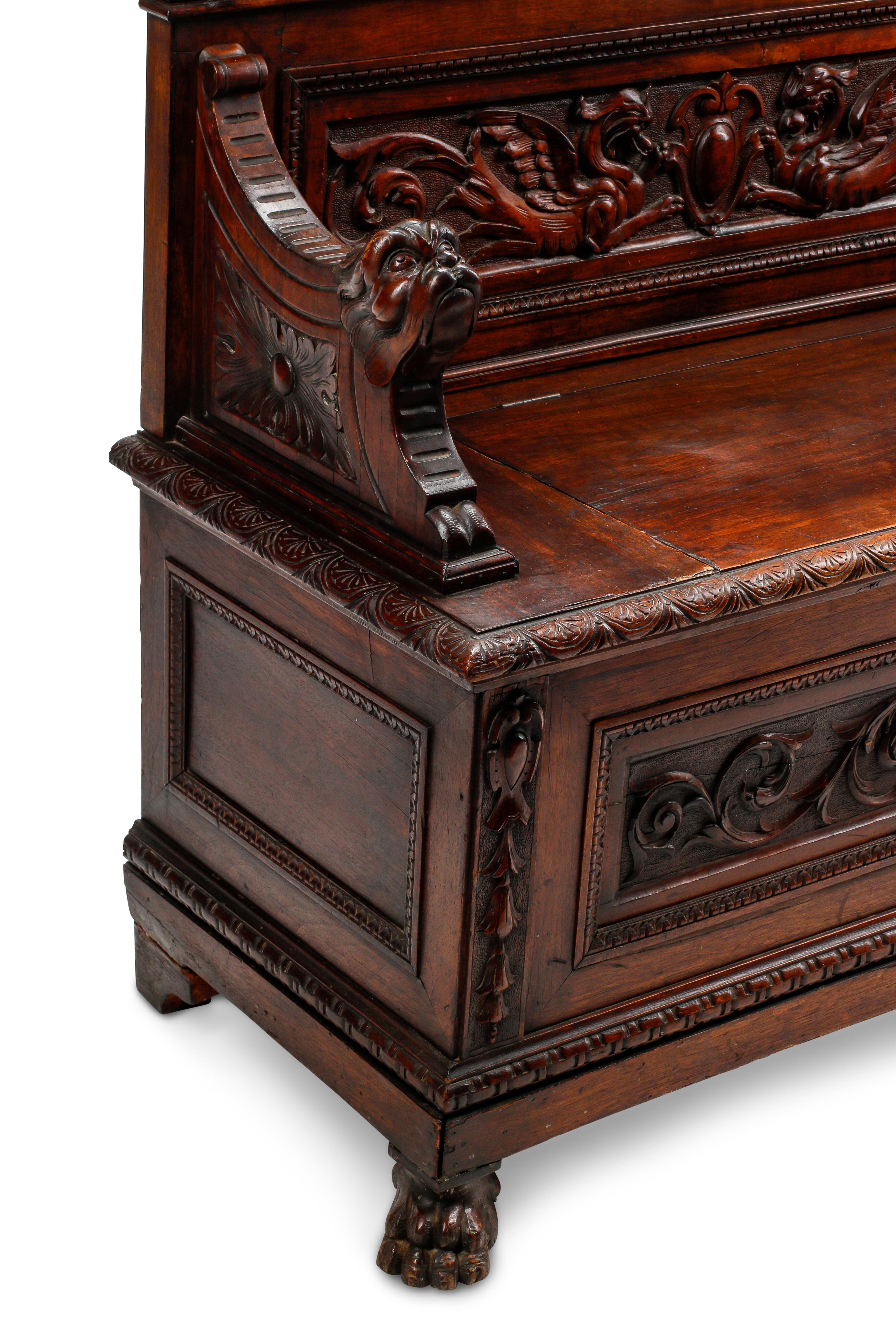 An Italian Renaissance Revival Carved Walnut Settle