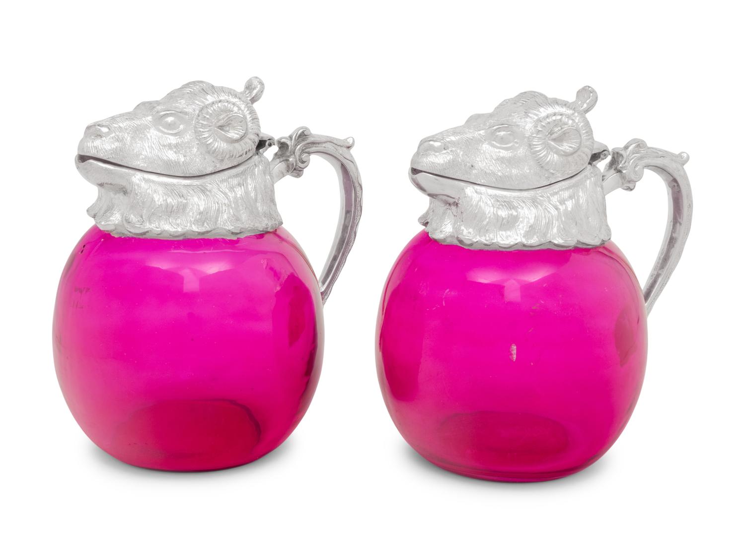 A Pair of Silver-Plate and Pink Glass Ram Decanters