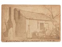 [EARLY PHOTOGRAPHY]. Irregular boudoir card of a pregnant African American woman outside of a home in Texas.