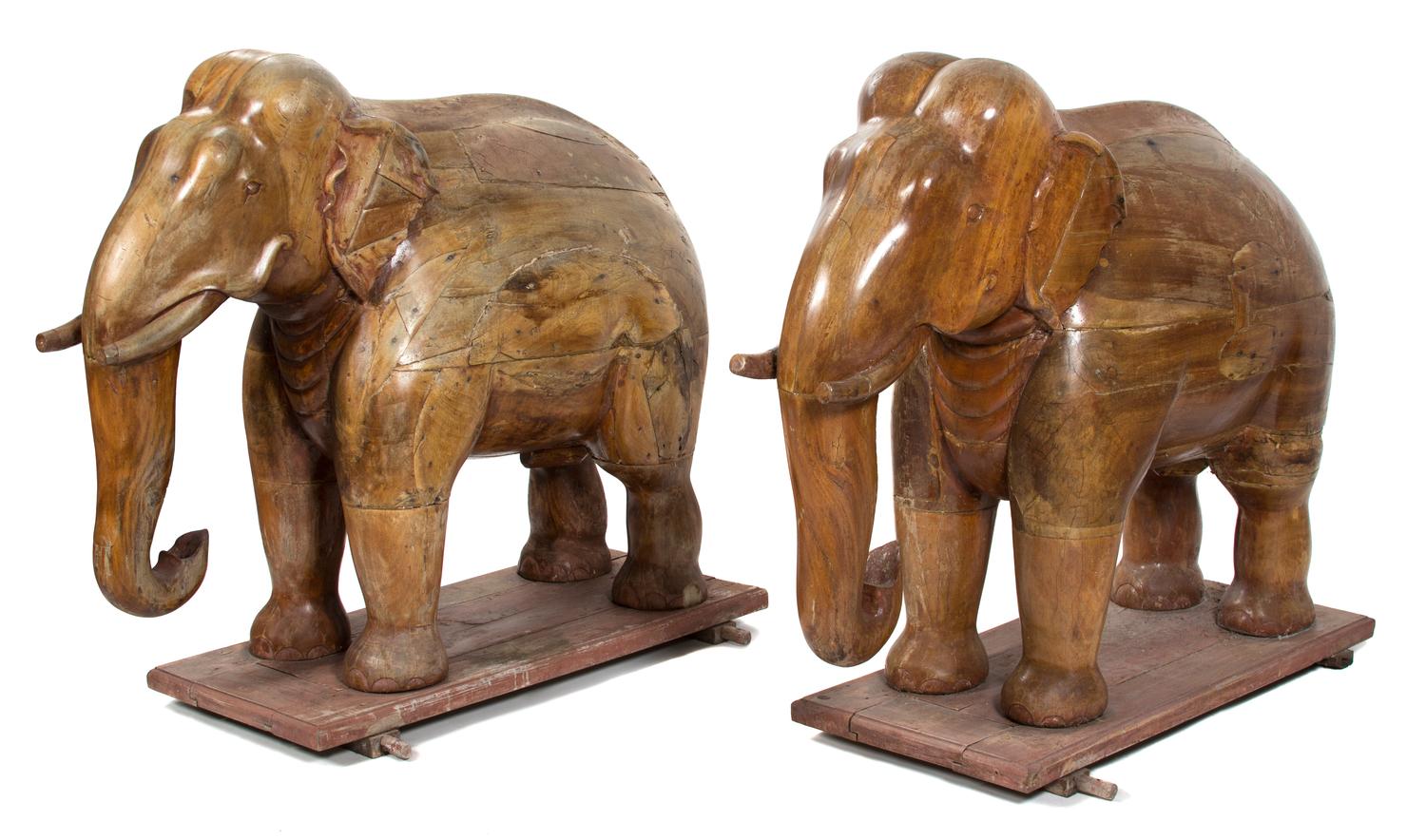 A Pair of Indian Carved Teak Models of Elephants Height 46 x width 23 x depth 52 inches.