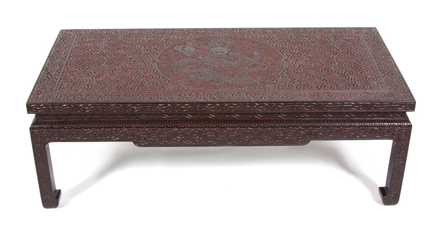 A Chinese Carved Black and Red Lacquer Low Coffee Table Height 16 x width 46 3/4 x depth 23 1/4 inches. — 20TH CENTURY