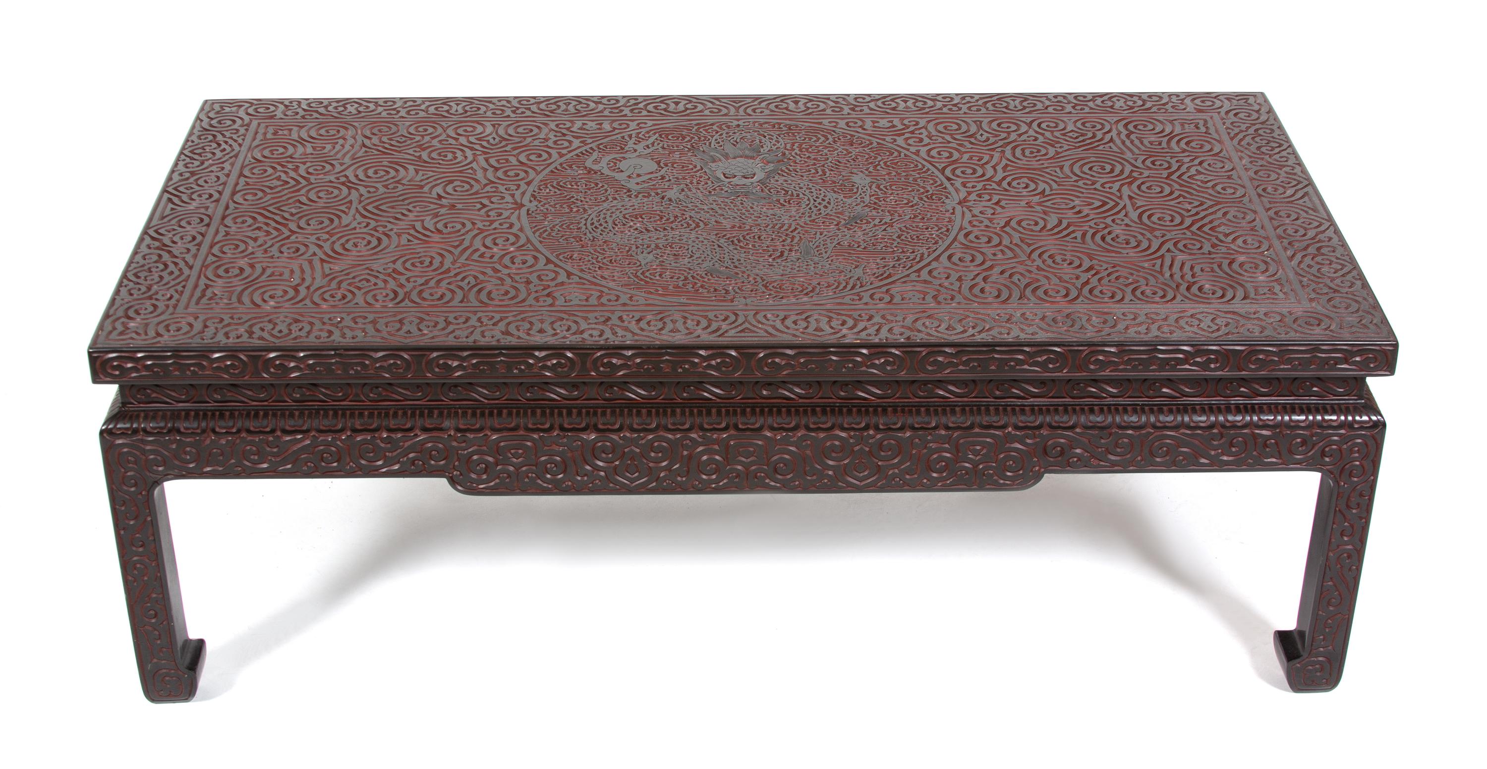 A Chinese Carved Black and Red Lacquer Low Coffee Table Height 16 x width 46 3/4 x depth 23 1/4 inches. — 20TH CENTURY