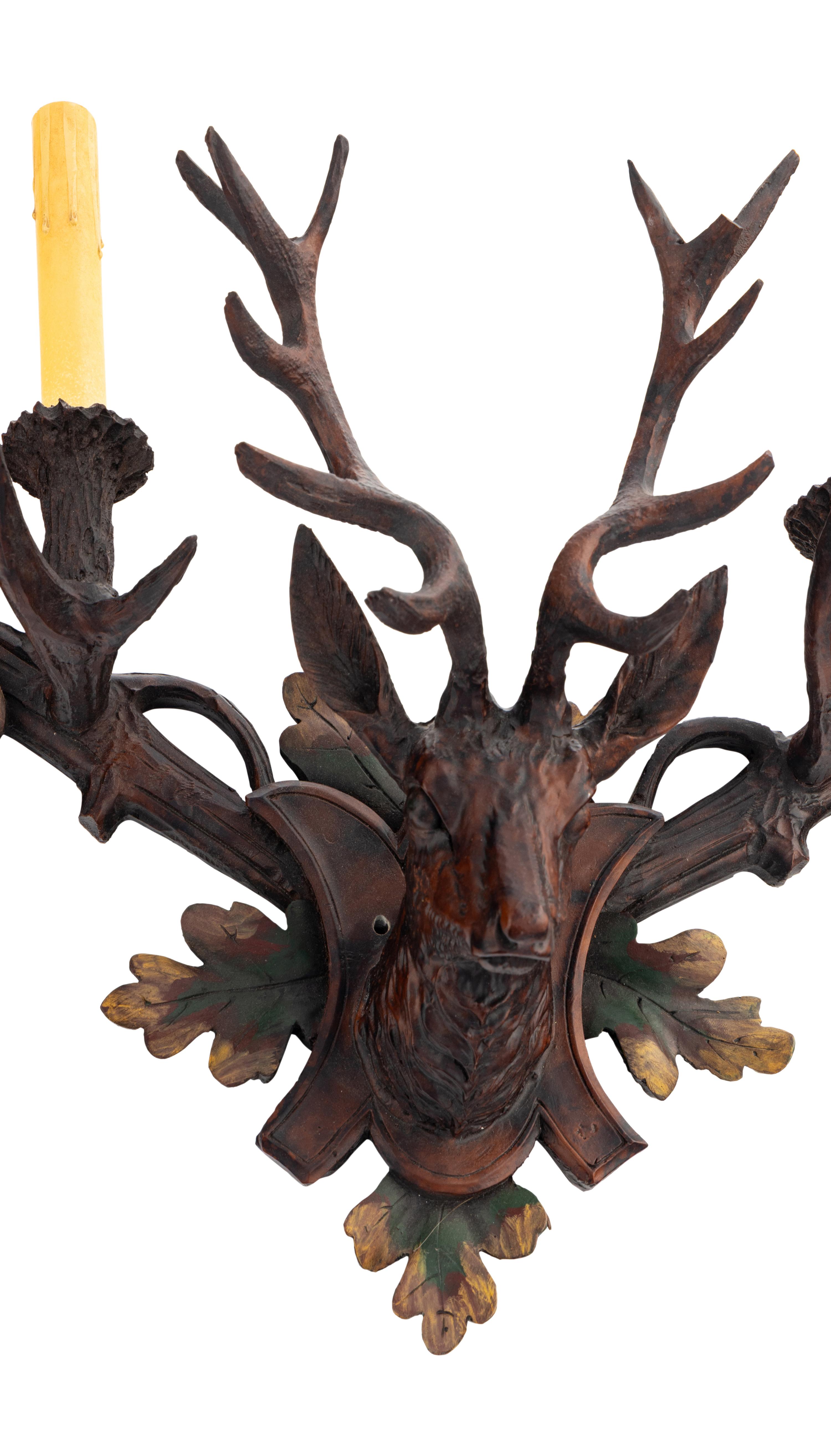 A Pair of Black-Forest Style Polychrome Decorated Two-Light Sconces