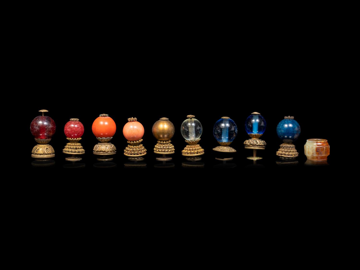 A Chinese Russet Jade Archer's Ring and Ten Chinese Hardstone and Gilt Bronze Hat Finials