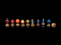 A Chinese Russet Jade Archer's Ring and Ten Chinese Hardstone and Gilt Bronze Hat Finials