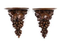 A Pair of Continental Carved Walnut Wall Brackets