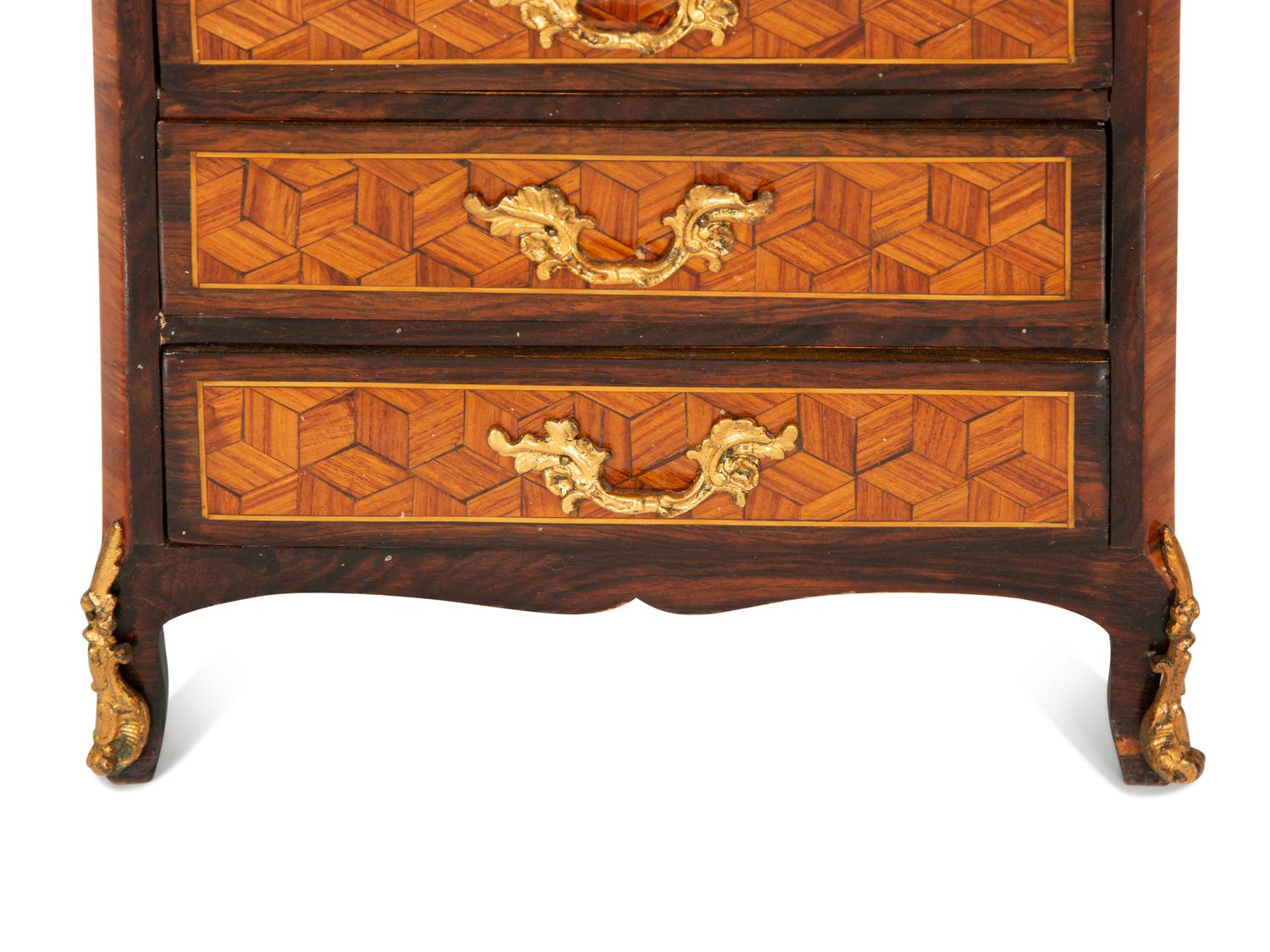 A Diminutive Gilt Bronze Mounted Parquetry Chest of Drawers