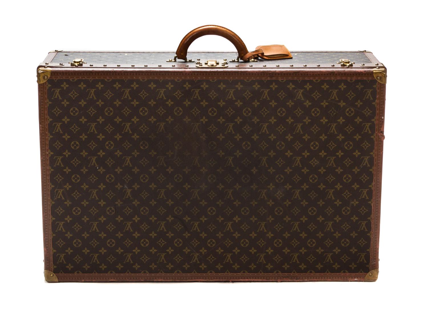 A Louis Vuitton Monogram Canvas Hard-sided Suitcase, 31 1/2 x 20 x 10 inches.