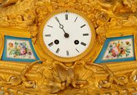 A Louis XV Style Gilt Bronze and Porcelain Inset Mantel Clock — 19TH CENTURY