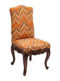 A Set of Eight Continental Carved Walnut Dining Chairs