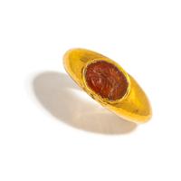 A Roman Gold and Carnelian Finger Ring with a Male Portrait Head