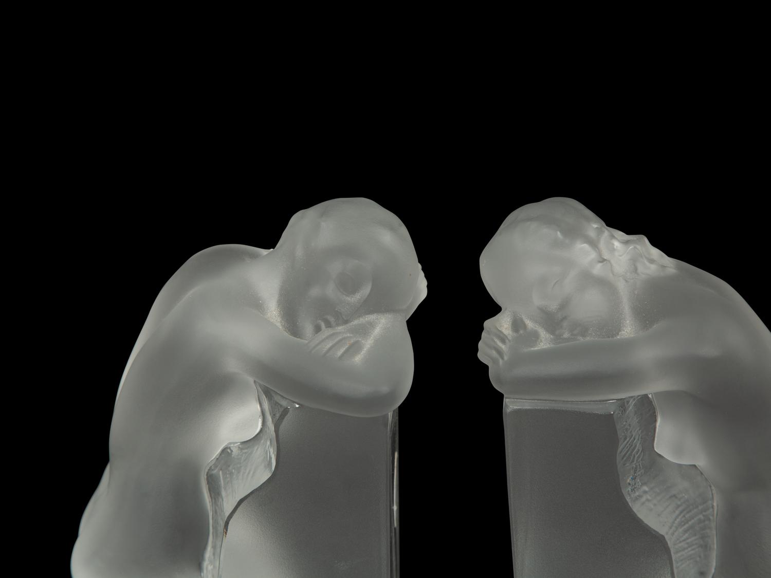 A Pair of Lalique Reverie Bookends and a Bacchantes Figural Group