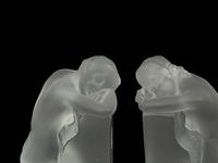 A Pair of Lalique Reverie Bookends and a Bacchantes Figural Group