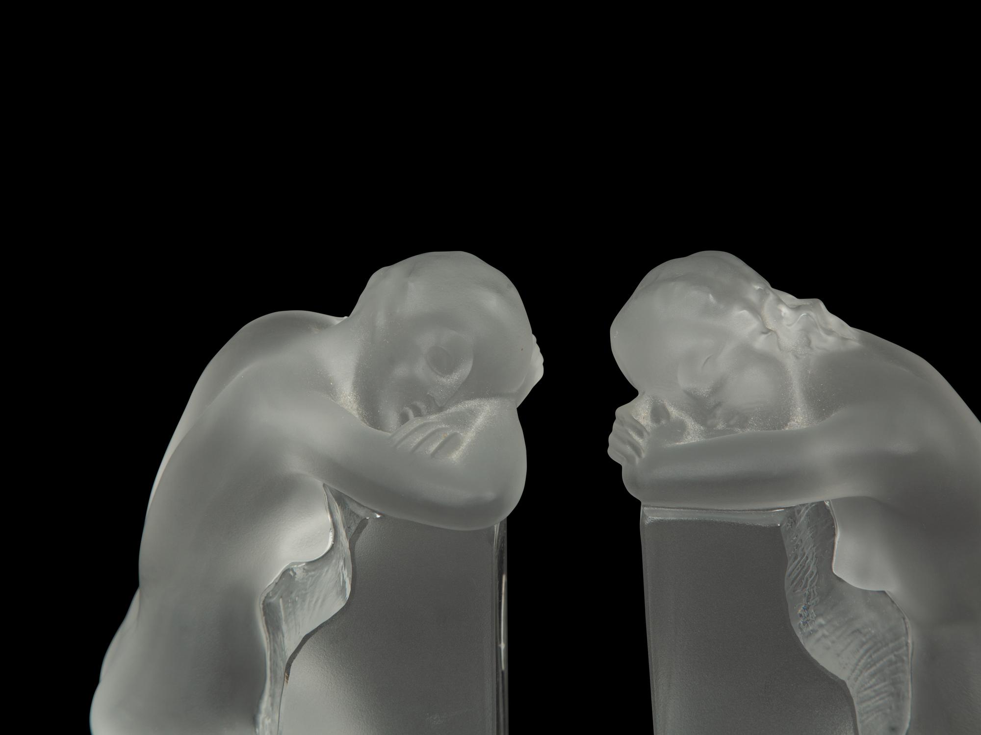 A Pair of Lalique Reverie Bookends and a Bacchantes Figural Group