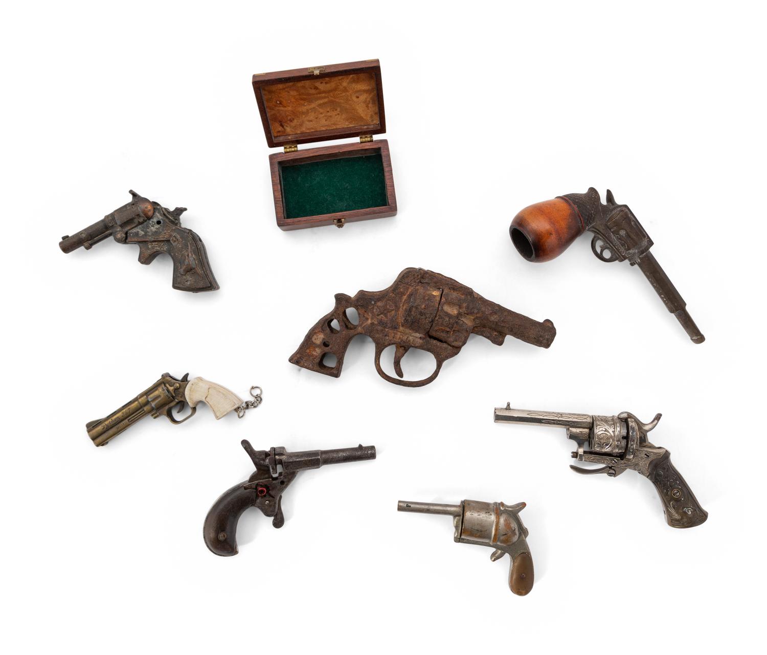 A Group of Eight Miniature Firearms Related Accoutrements