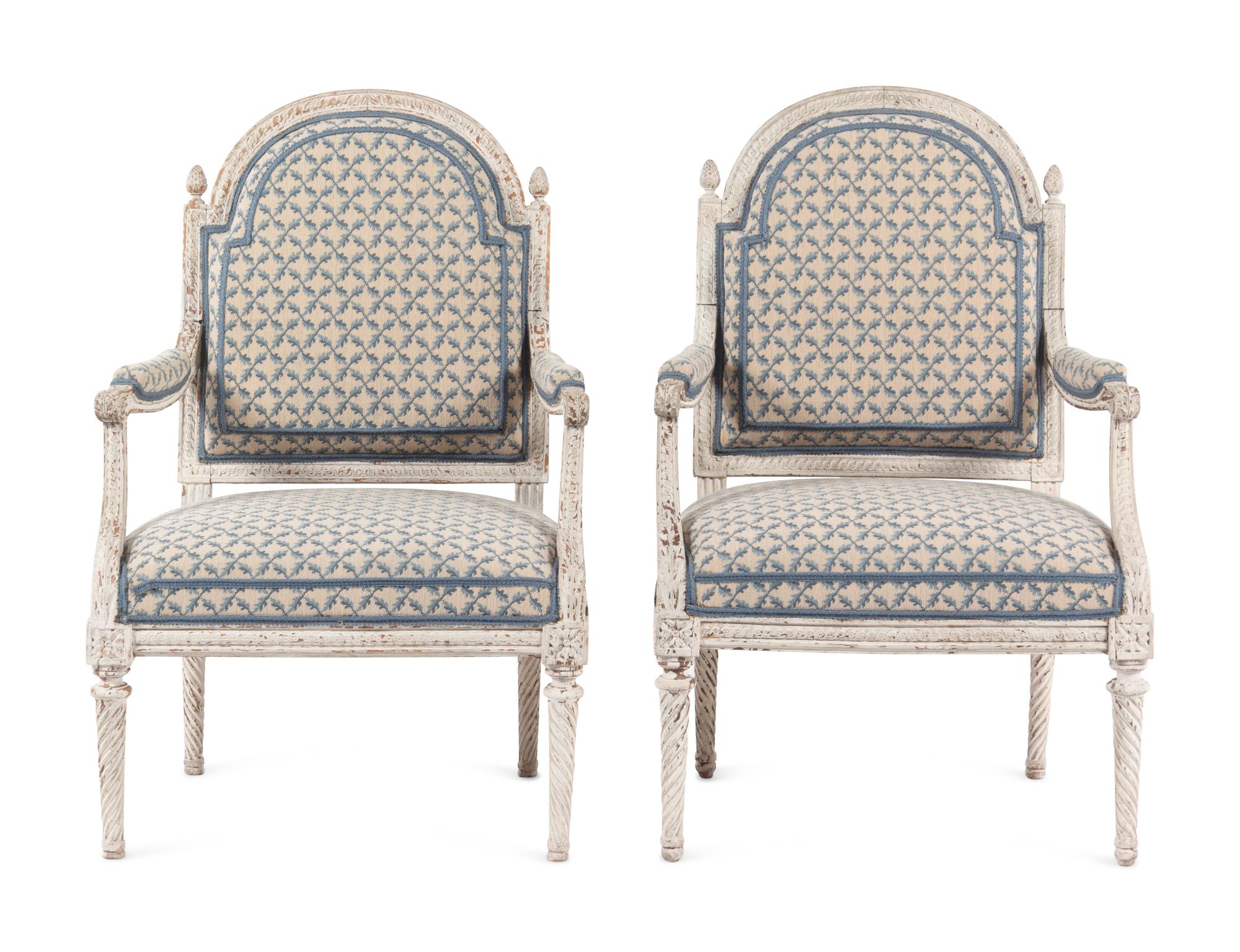 A Pair of Louis XVI Provincial White-Painted Fauteuils